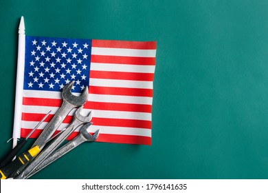 Labor day concept, Different kinds wrenches with American flag on dark green. First Monday in September, creation of labor movement and dedicated to social and economic achievements of American worker