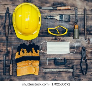 Labor Day Concept On Wood Background. Engineer And Worker Tools With Construction Safety Equipment And Mask. Safety First Concepts