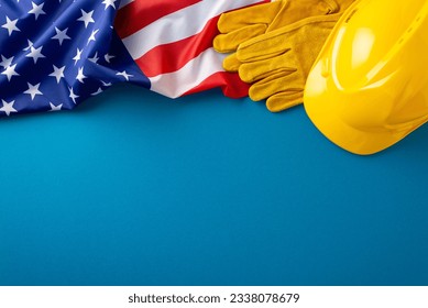 Labor Day handyman essentials. Top view of USA flag, work gloves, safety helmet on blue background with space for handyman services - Shutterstock ID 2338078679