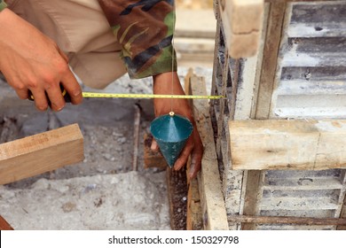 labor man using a plumb bob for check 	 pillar