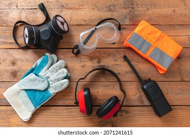 Labor Personal Protective Gear. Work Health And Safety For Industry And Construction Site. Protection Equipment On Wooden Background,