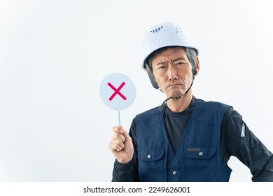 A labor showing a cross sign. - Shutterstock ID 2249626001