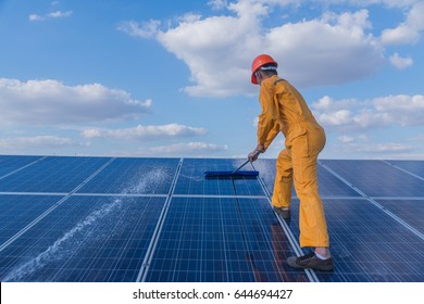 Labor Working On Cleaning Solar Panel At Solar Power Plant