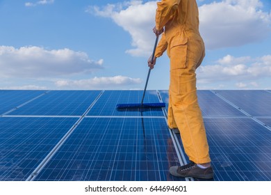 Labor Working On Cleaning Solar Panel At Solar Power Plant