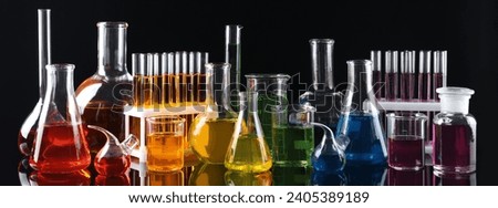 Laboratory analysis. Different glassware with colorful liquids on black background, banner design