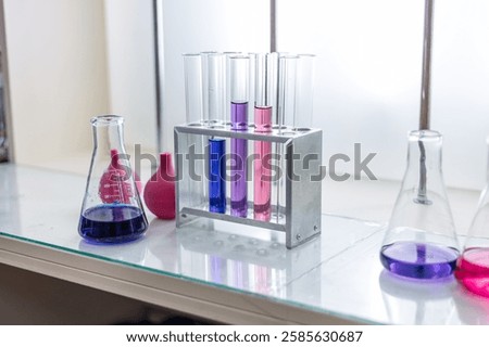 Laboratory analysis. Flask and test tubes on white table indoors, closeup. Laboratory test-tubes and retorts. Scientific equipment at laboratory.