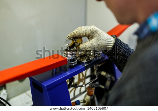 Laboratory assistant checks the quality of\
petroleum products in the\
laboratory