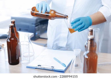 Laboratory assistant inspecting production beer, analysis drink in glasses. Concept brewery food industry. - Powered by Shutterstock