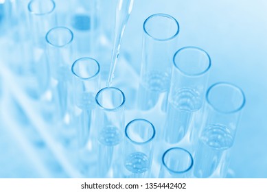 Laboratory beaker in analyst's hand in plastic glove - Shutterstock ID 1354442402