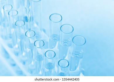 Laboratory beaker in analyst's hand in plastic glove - Shutterstock ID 1354442405