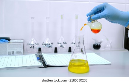 Laboratory of chemical analysis .A woman 's hand in a blue medical glove makes an analysis of drinking water . The concept of science and chemistry - Shutterstock ID 2185030235