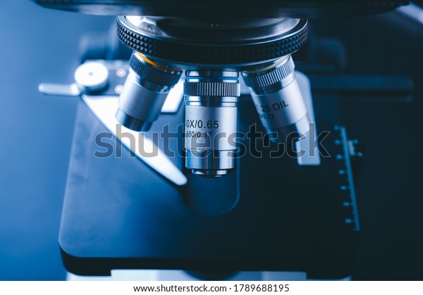 Laboratory\
equipment optical microscope, closeup of scientific microscope with\
metal lens, data analysis in the\
laboratory
