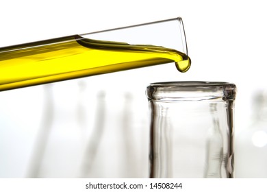 Laboratory Glass Test Tube Filled With Yellow Liquid Pouring A Drop Of Chemical Solution Into A Scientific Cylinder Flask An Experiment In A Science Research Lab 
