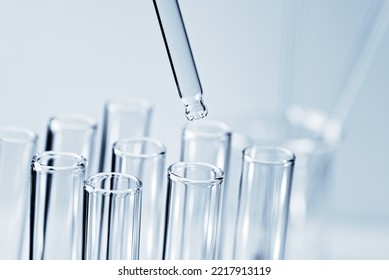 Laboratory Glassware With Dropper Into Test Tube Close Up Macro Photography. Science Background. Laboratory Equipment Glassware. Concept Of Medical Or Science Laboratory