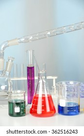 Laboratory glassware on table with flasks and beakers and distillation set