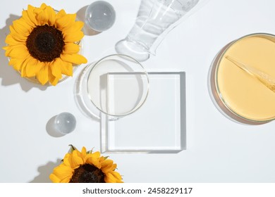 Laboratory glassware and sunflower placed surround a glass platform in center, harmonious arrange flat lay style on white background. Space for presentation with view from above - Powered by Shutterstock