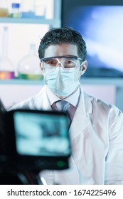 Laboratory Hospital Clinic Doctor, Scientist Or Exper, Wearing Protacive Mask While Addressing Public In Media Interview Explaining Preventive Measures Against Corona Virus Pandemic Outbreak.