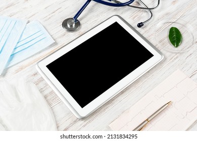 Laboratory Patient Examination In Doctors Office. Top View Tablet Computer, Stethoscope And Cardiogram On Wooden Desk. Medical Diagnostics And Examination In Modern Hospital. Healthcare Technology