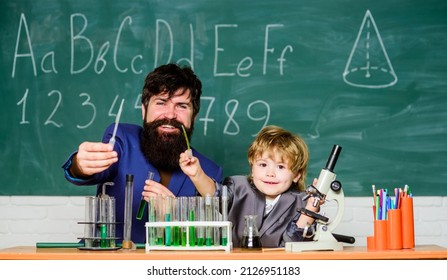 laboratory research and development. Chemistry beaker experiment. father and son child at school. bearded man teacher with little boy. Laboratory test tubes and flasks with colored liquid - Powered by Shutterstock