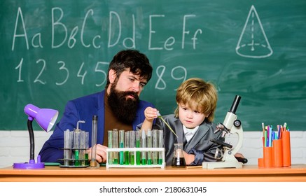 laboratory research and development. father and son child at school. bearded man teacher with boy. lab test tubes and flasks with colored liquids Chemistry experiment. Chemistry come as you are - Powered by Shutterstock