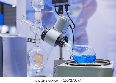 Laboratory rotary evaporator - homogenization process - rotating chemical flask for evaporate solvent from blue liquid at pharmacy factory or medical exhibition. Pharma, chemistry and science concept