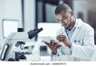 Laboratory scientist or science professional with tablet writing or recording medical research innovation in healthcare centre. Serious biologist searching for pandemic virus vaccine cure on lab - Powered by Shutterstock