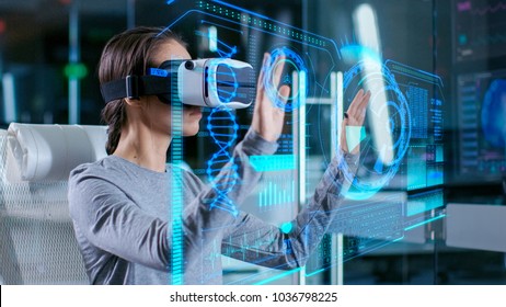 In Laboratory Scientist Wearing Virtual Reality Headset Sitting in a Chair Interacts with Futuristic Holografic Interface, Showing Neurological Data. Modern Brain Study/ Neurological Research Center.