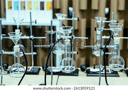 A laboratory setup featuring multiple glass apparatuses for experiments, reflecting a clean and organized scientific environment.