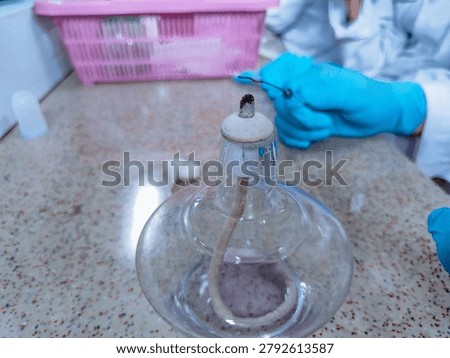 Laboratory sterilization technique using Bunsen burner and inoculating loop.