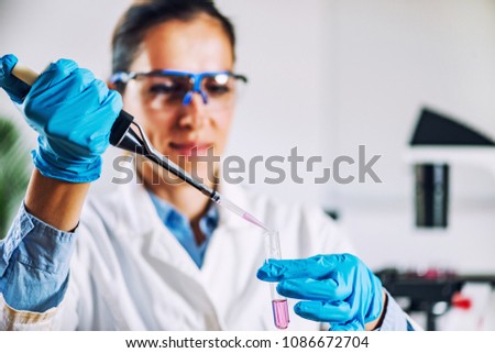 Laboratory technician with micro pipette