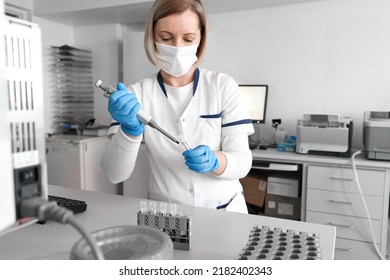 Laboratory technician working with samples and a centrifuge reaction vessel - Powered by Shutterstock