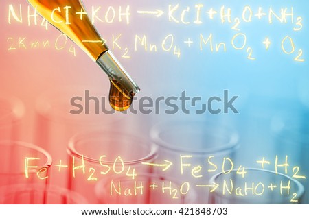 laboratory test tubes with gold chemical equation background