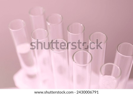 Laboratory test tubes on colored background