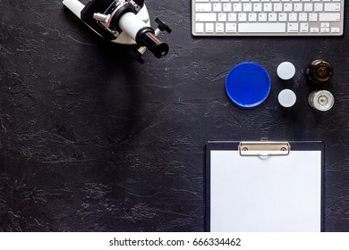 Laboratory tests. Work table witn microscope, Petri dish and pad on stone background top view mockup copyspace