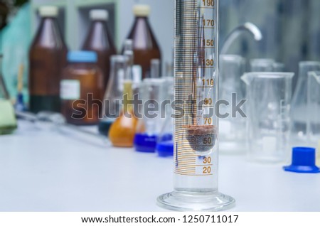 Laboratory thermometer, hydrometer and measuring cylinder