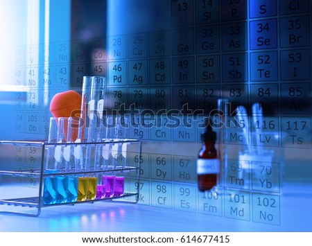 laboratory tools with color liquids solution in glassware and Periodic table of elements in lab