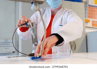 Laboratory Worker Heating Material Over Gas Bunsen Burner Flame in Chemistry Lab