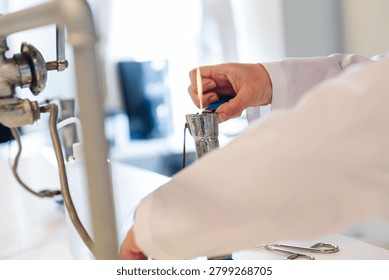 Laboratory Worker Heating Material Over Gas Bunsen Burner Flame in Chemistry Lab