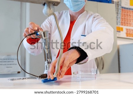Laboratory Worker Heating Material Over Gas Bunsen Burner Flame in Chemistry Lab
