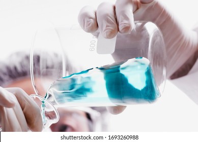 laboratory worker holding flask close up