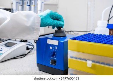 Laboratory worker mixes samples with a vortex mixer in preparation for HPLC analysis - Powered by Shutterstock