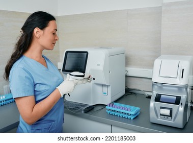 Laboratory worker scanning barcode of test tube with blood on her workplace near medical research machine - Powered by Shutterstock - Get 15% off with code: PIKWIZARD15