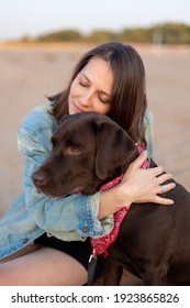 Labrador Retriever, Happy And Young Caucasian Millennial Woman In Denim Jacket Hugs Dog And Smiles, Dog And Human Friendship, Pet, Pit Bull, Dog Lover, Walking. Soft Selective Focus