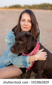 Labrador Retriever, Happy And Young Caucasian Millennial Woman In Denim Jacket Hugs Dog And Smiles, Dog And Human Friendship, Pet, Pit Bull, Dog Lover, Walking. Soft Selective Focus