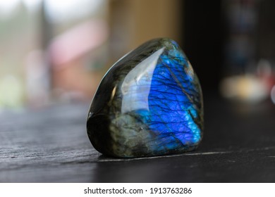 Labradorite Mineral Stone On Slate Worktop.