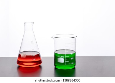 Labratory Beakers Filled With Colored Liquid On A Table