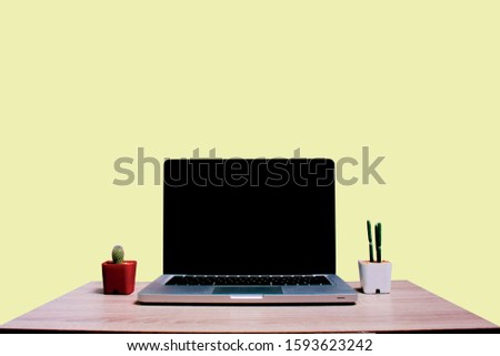 Labtop copy space with two cactus on pastel colour background