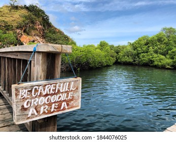 Labuan Bajo, April 2020 . An Appeal Board And A View Of The Water Surrounded By Trees