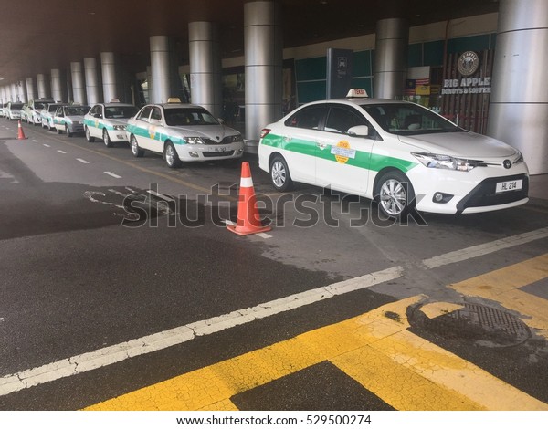 Labuan,Malaysia-Dec 5,2016:Taxi queued for\
passengers at Labuan Airport,Labuan,Malaysia on 5th Dec 2016.One\
benefit of Taxis vs Uber,is that taxi companies do allow customers\
to pre-book their\
rides