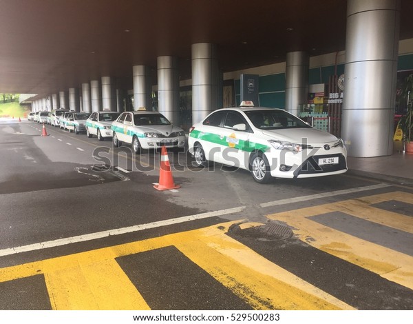 Labuan,Malaysia-Dec 5,2016:Taxi queued for\
passengers at Labuan Airport,Labuan,Malaysia on 5th Dec 2016.One\
benefit of Taxis vs Uber,is that taxi companies do allow customers\
to pre-book their\
rides